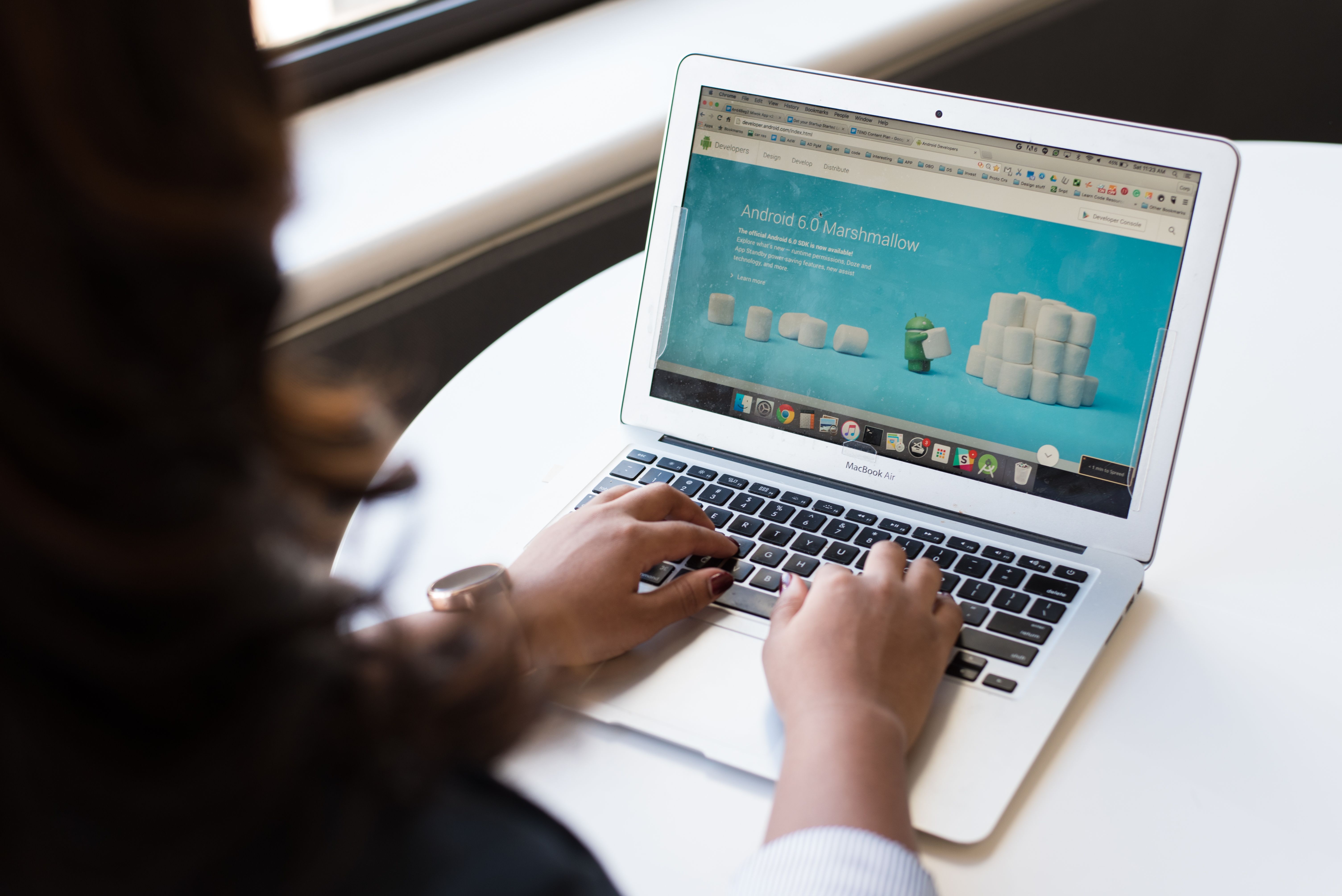 A picture of a person at their laptop on a website.