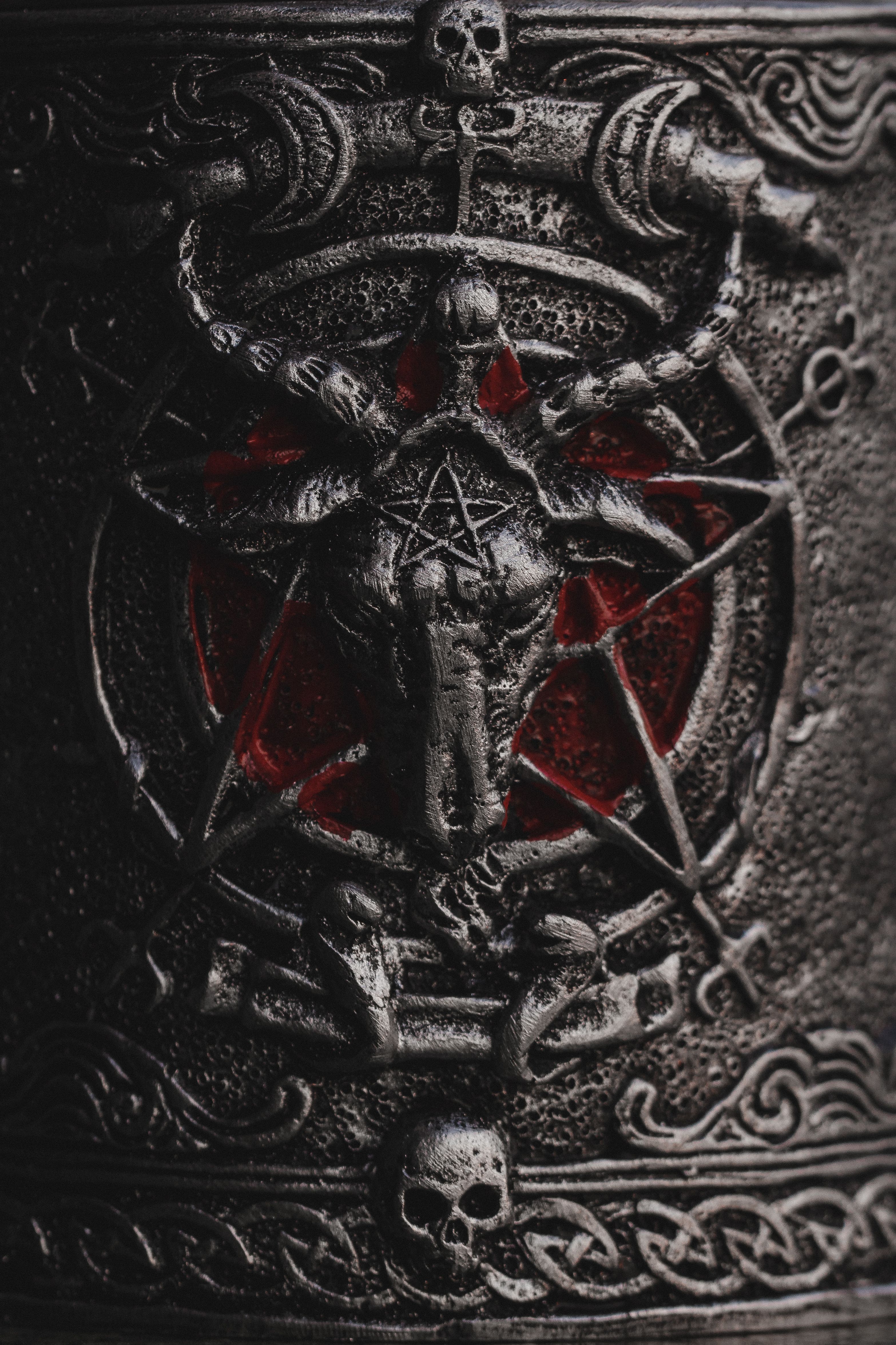 a picture of a stone engraving of a goat on top of a pentagram, there is red around the goat.